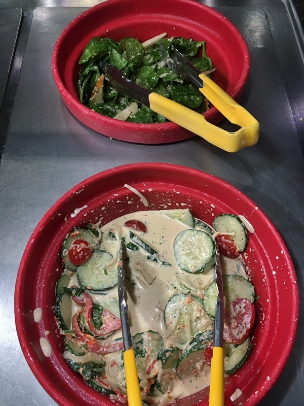 a couple dishes of food on a buffet line