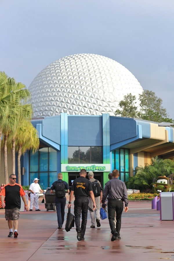 A group of people walking toward Spaceship Earth in Epcot