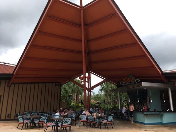 A group of outdoor tables and chairs under a covered area