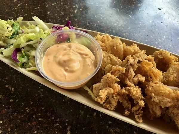 fried calamari with sauce on a long platter