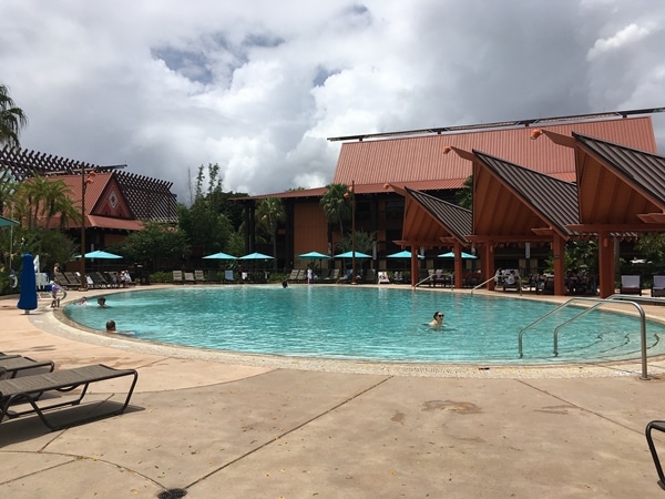 a hotel swimming pool with very few people swimming