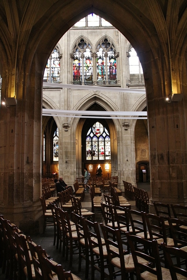 interior of a church with rows of chairs and stained glass windows