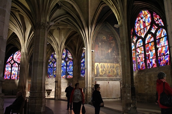 several colorful stained glass windows in a church