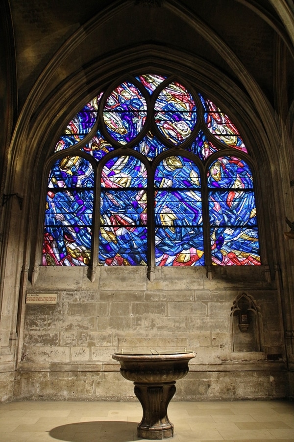 a bright blue stained glass window in a church