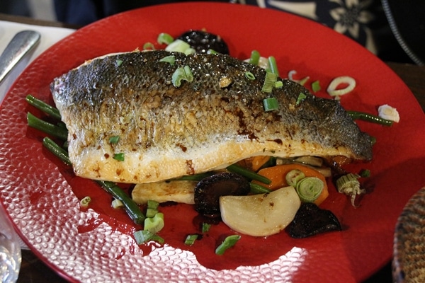 fish and vegetables on a red plate