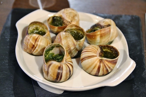 a plate of escargots with garlic butter