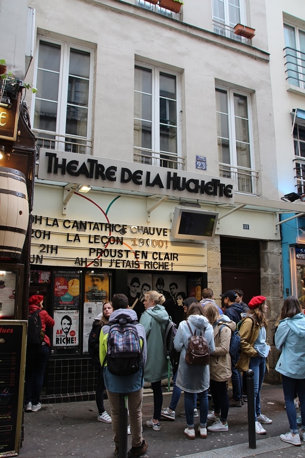 A group of people standing in front of a building