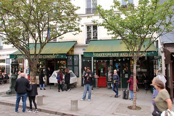 A group of people walking on a sidewalk