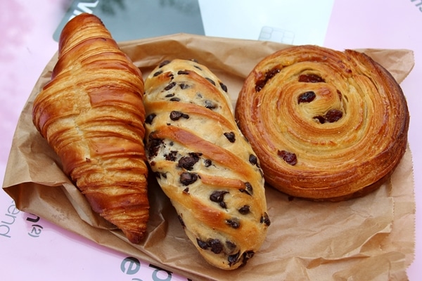 3 French breakfast pastries on a paper bag