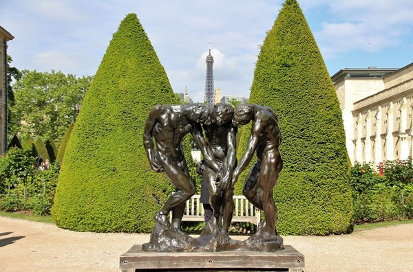 A statue in front of some trees