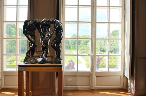 sculptures next to a large window overlooking a garden