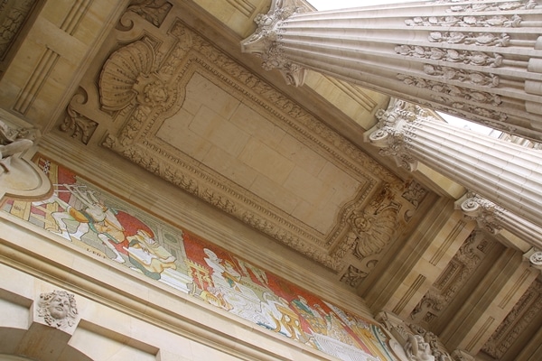 view looking up at a tall ceiling held up by columns