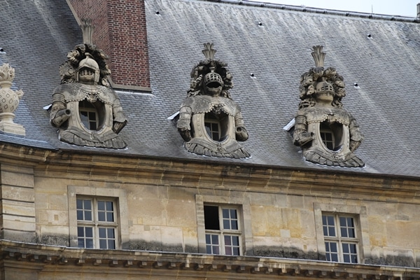 closeup of ornate windows on a stone building