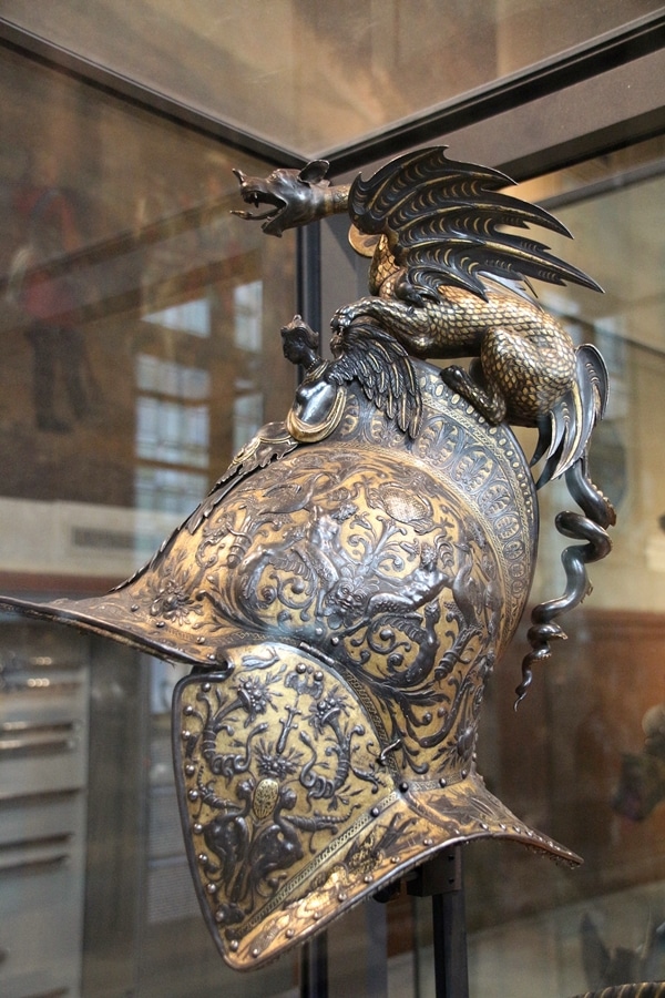 a metal helmet with a dragon on top