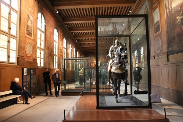 a museum display of suits of armor on horses