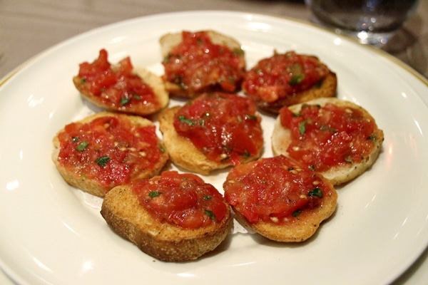 A plate of bruschetta on a white plate