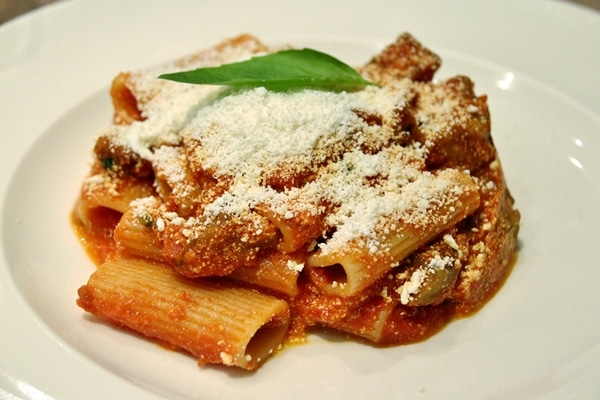 rigatoni with grated cheese and basil on top