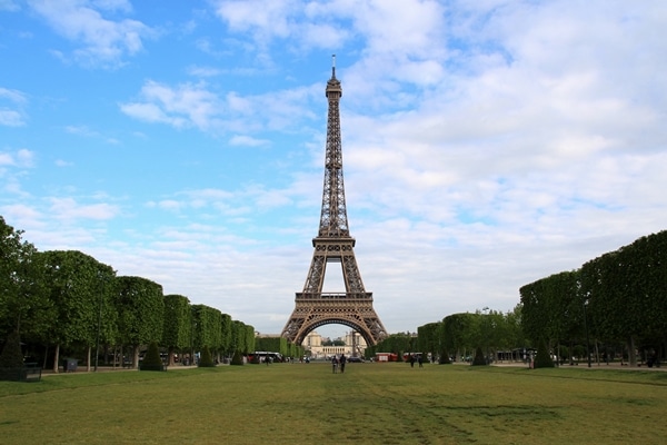 the Eiffel Tower at the end of a large grassy field