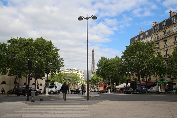 A view of a city street with the Eiffel Tower in the distance