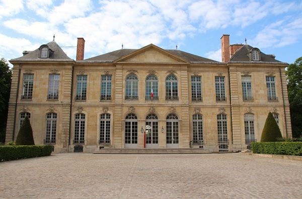 a grand stone building with a large courtyard in front