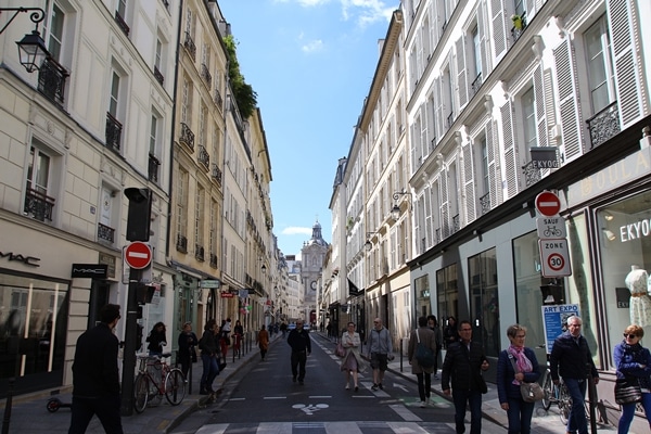 A group of people walking on a city street