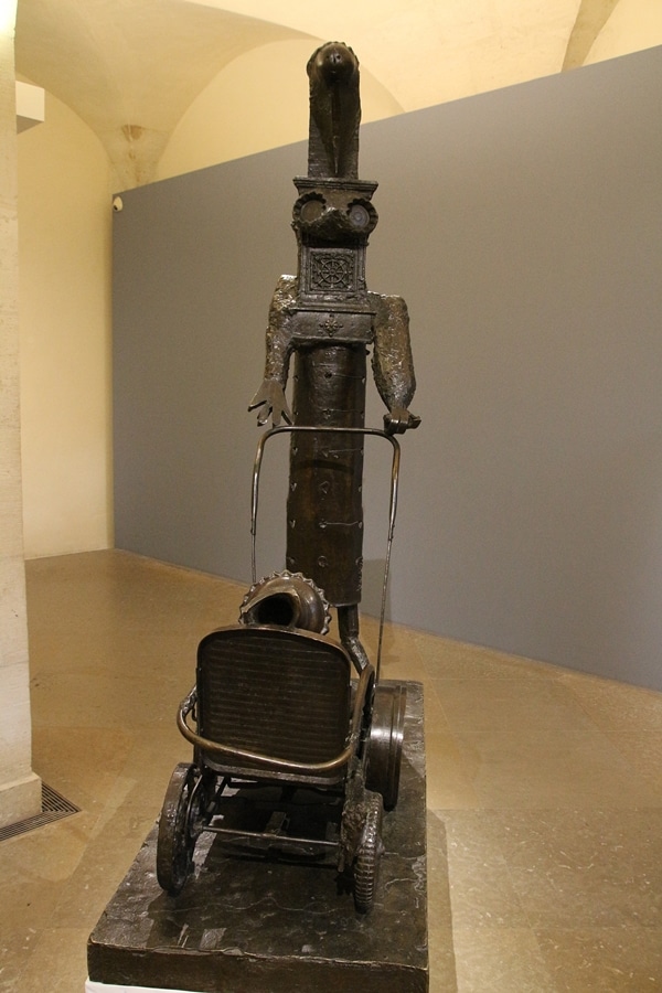 an unusual looking Picasso statue in a museum