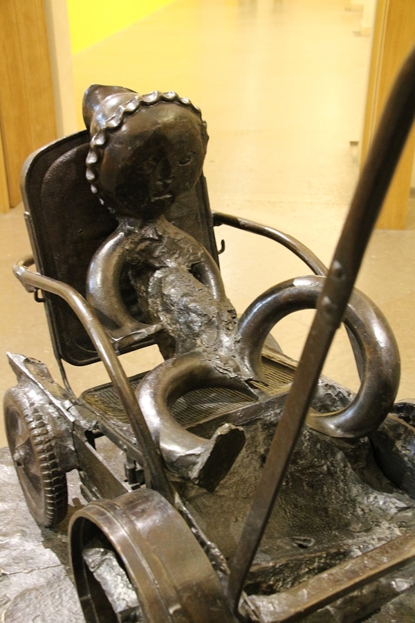 a Picasso statue of a baby in a carriage