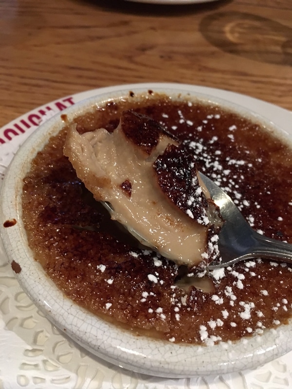 a spoonful of creme brulee with a caramelized sugar top