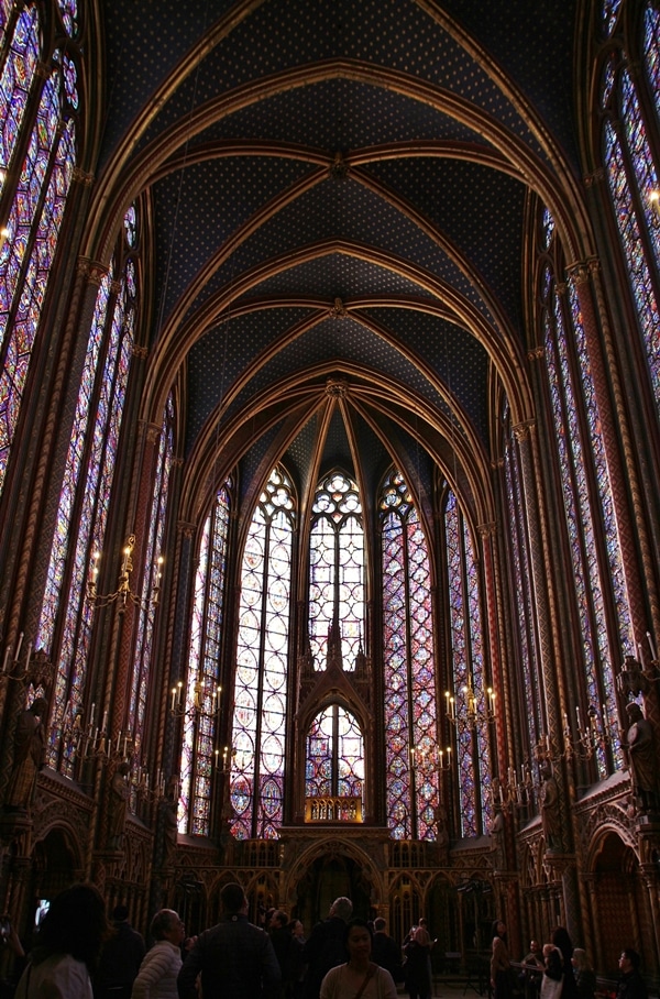 The interior of Sainte-Chapelle church with tall picture windows and vaulted ceilings