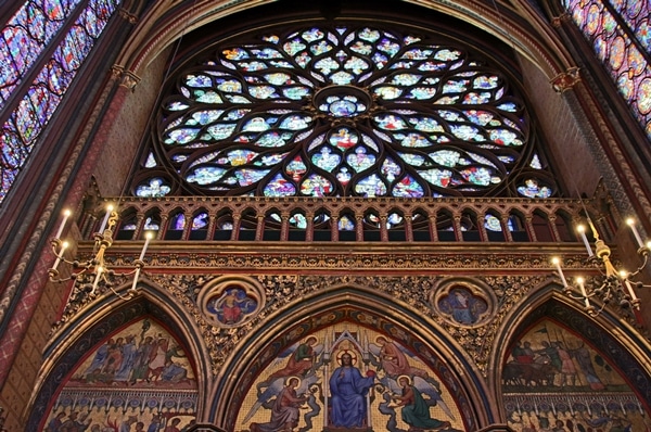 closeup of a round stained glass rose window in a church