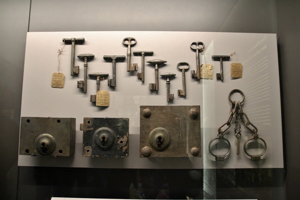 a bunch of old keys and locks in a museum display