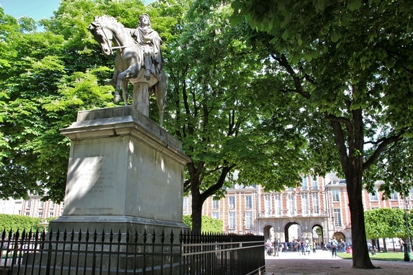 A statue in front of a tree