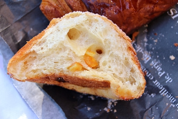 a cross section of a piece of brioche filled with orange zest