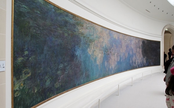 a large painting stretching across a curved wall