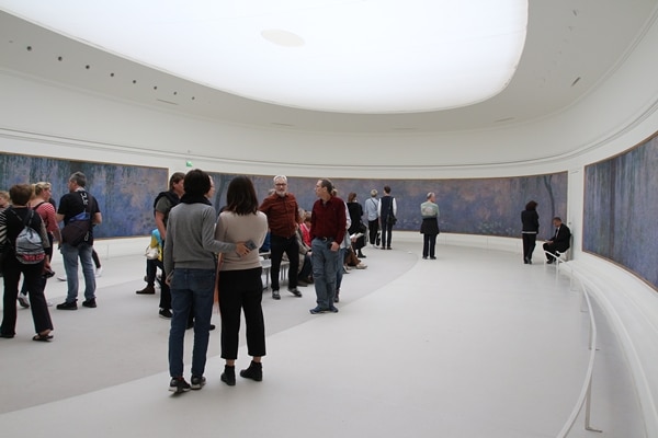 A group of people standing in a room in a museum