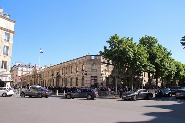 cars on a street in front of a building