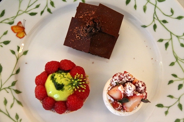 3 beautifully decorated desserts on a white plate