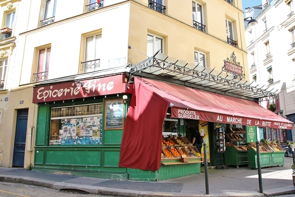 a corner grocery market with red awning