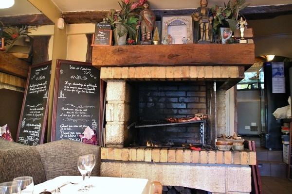 A fire place in a small cozy restaurant dining room