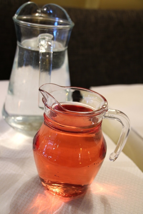 a small glass carafe of rose wine