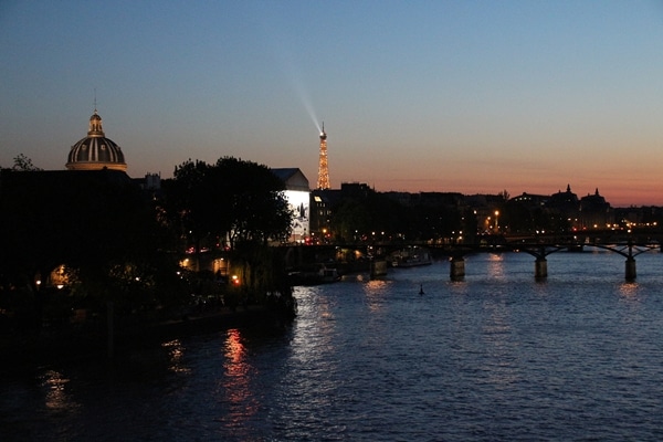 nighttime view of the River Seine and Eiffel Tower in the distance