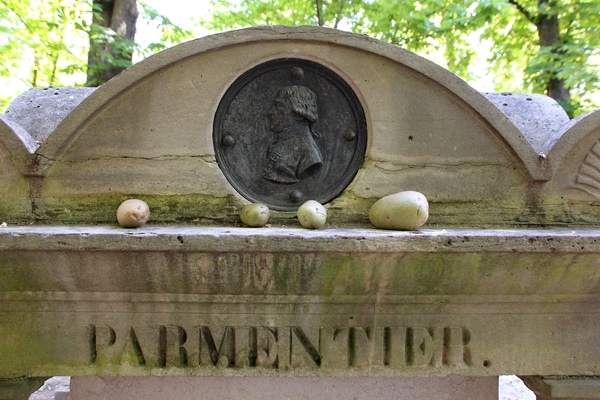 A closeup of Parmentier\'s grave with potatoes on it