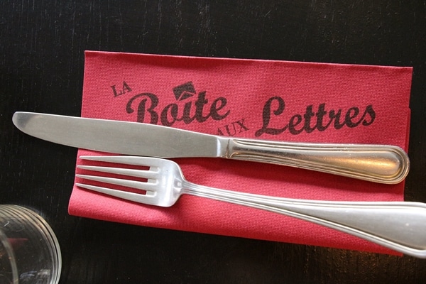 a fork and knife on a red paper napkin