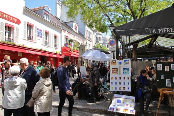 a bustling Parisian square filled with artists and tourists