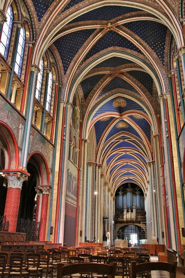 large church interior with brightly colored ceiling and walls