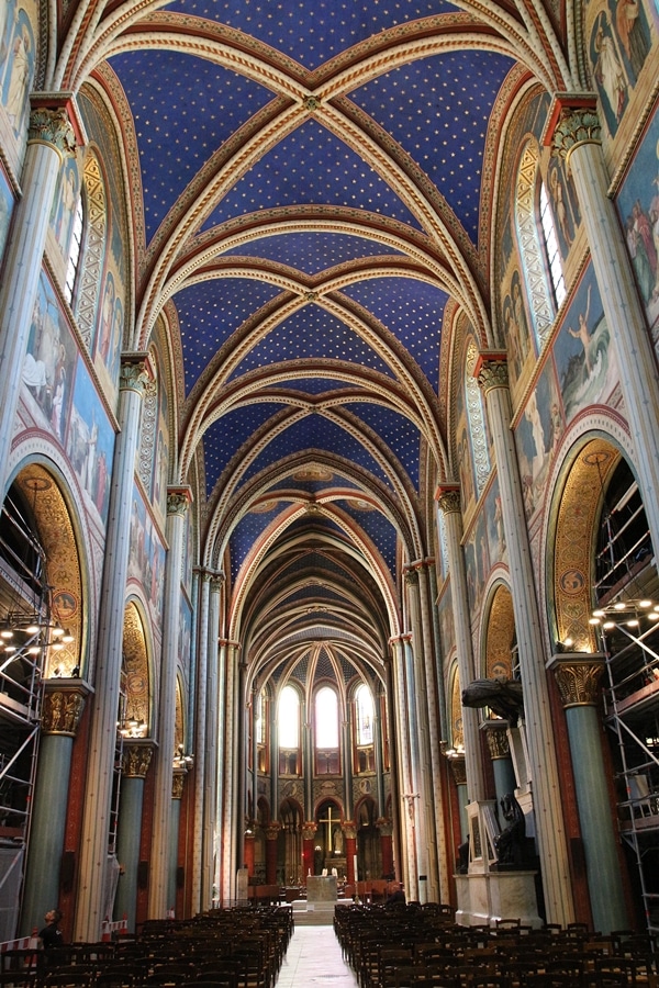 interior of a large church with blue vaulted ceiling