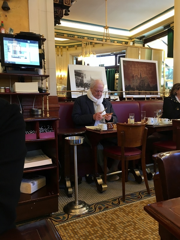 an older man sitting at a restaurant table