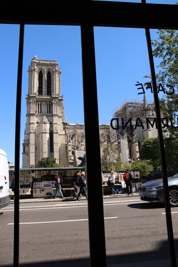 view through a window of Paris\'s Notre Dame Cathedral