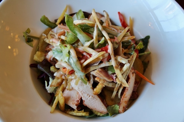 salad with chicken and vegetables in a wide bowl