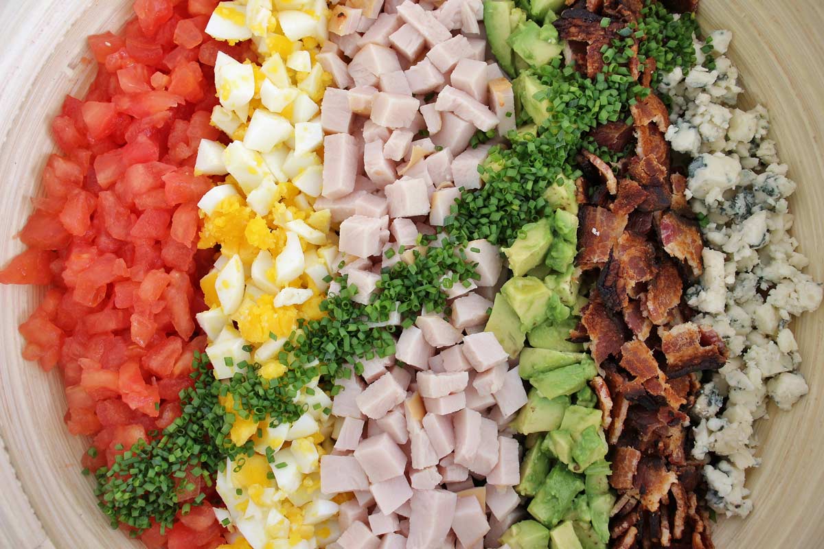 Hollywood Brown Derby Cobb salad with colorful toppings arranged in perfect rows.